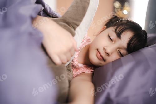 Preview: asian children girl are sleep on bed at home, little young cute daughter having bedtime to relax
