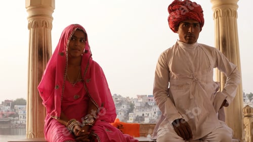 Preview: Closeup of an Indian couple in traditional outfits sitting in the temple.