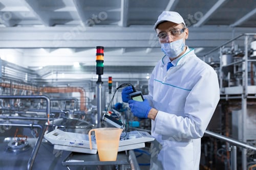 Preview: man in a mask and a Bathrobe connects the dosimeter to the dairy Plant