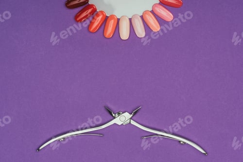 Preview: top view of nail nippers and manicure palette isolated on purple