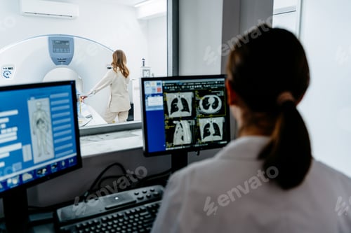 Preview: Medical professional analyzing scans during tomography procedure