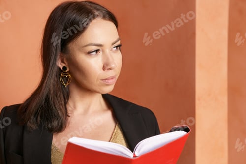 Preview: Beautiful successful young brunette business woman in black jacket, against