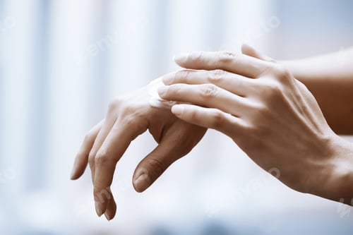 Preview: Woman applying moisturizing cream on hands