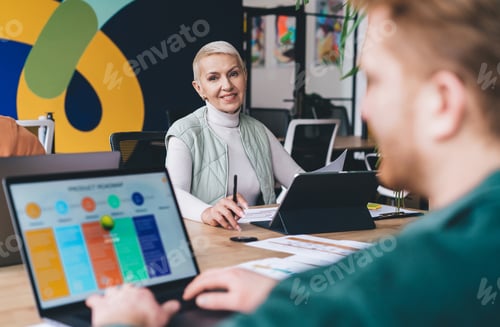Preview: successful mature employee with digital tablet