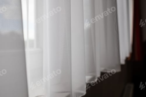 Preview: White transparent curtain closes the window, indoors.