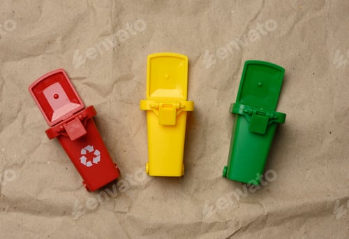 Preview: Three multi-colored plastic containers on a brown paper background
