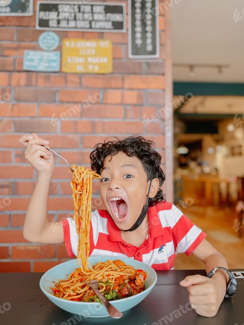 Preview: Excited Child with Spaghetti Meal at a Restaurant