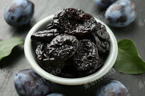 Preview: Dried prunes and fresh plums on black table, closeup