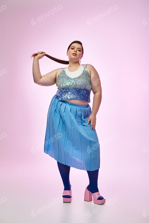 Preview: Plus size woman showcasing vibrant fashion against a pastel background in a playful pose