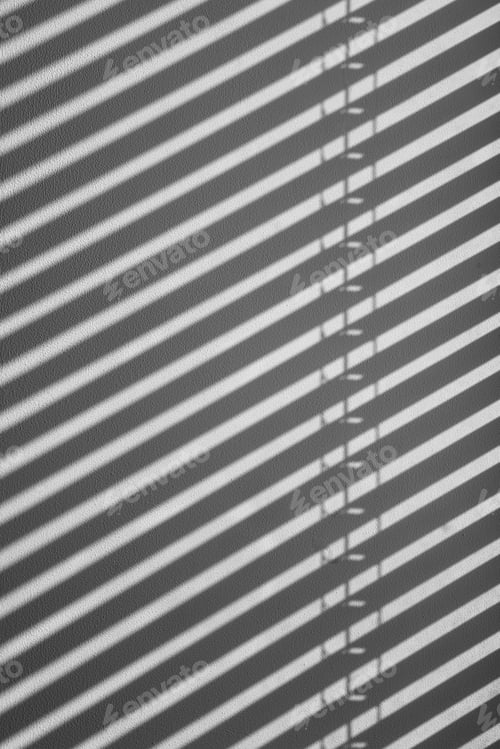 Preview: Sunlight and blinds create a shadow on the white wall