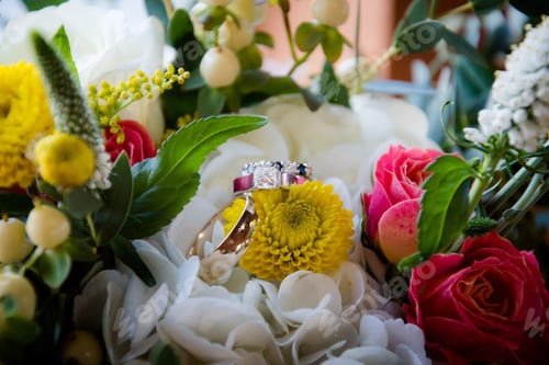 Preview: Wedding rings on a flower in a beautiful bouquet