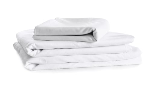 Preview: Stack of clean bed linen isolated on white