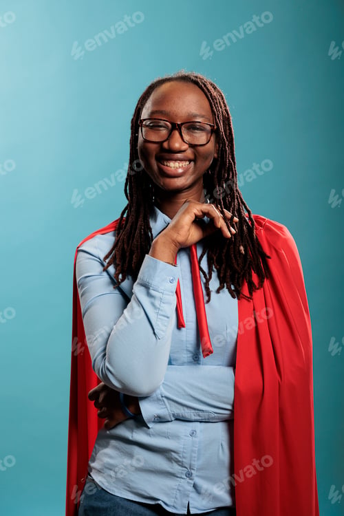 Preview: Happy positive smiling justice defender superhero woman wearing hero mighty cape while smiling at