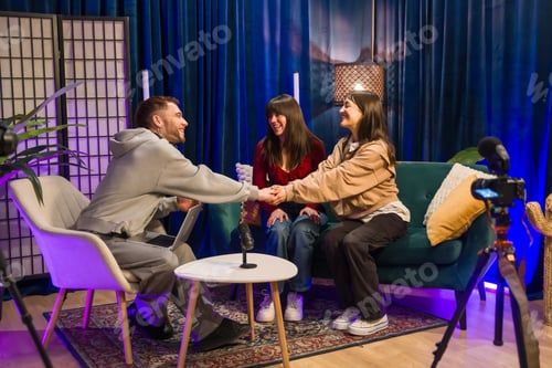 Preview: Content creators shaking hands recording social media podcast interview