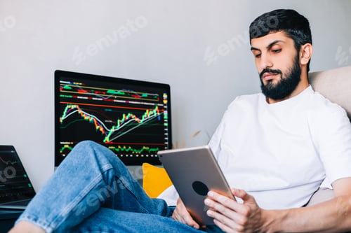 Preview: Caucasian businessman trading online, using computer technology, looking on stock exchange