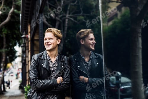 Preview: Portrait of young blonde man by window