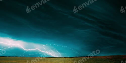 Preview: Countryside Rural Wheat Field Meadow Landscape In Summer Rainy Day. Scenic Sky With Rain Clouds On