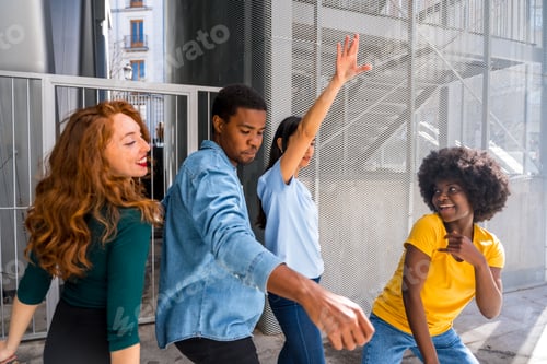 Preview: Multiethnic young friends dancing in the city, millennial fun with music