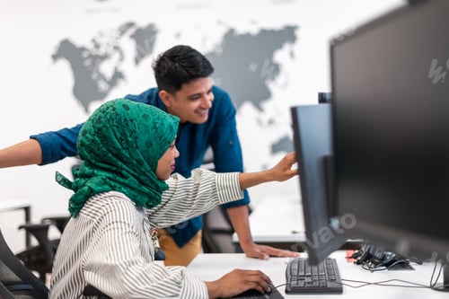 Preview: Multiethnic startup business team woman wearing a hijab on meeting in modern open plan office