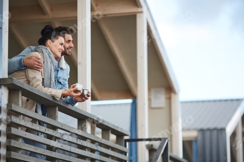Preview: Cheerful couple contemplating nature on balcony