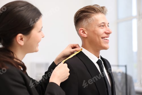 Preview: Tailor measuring jacket on man in atelier