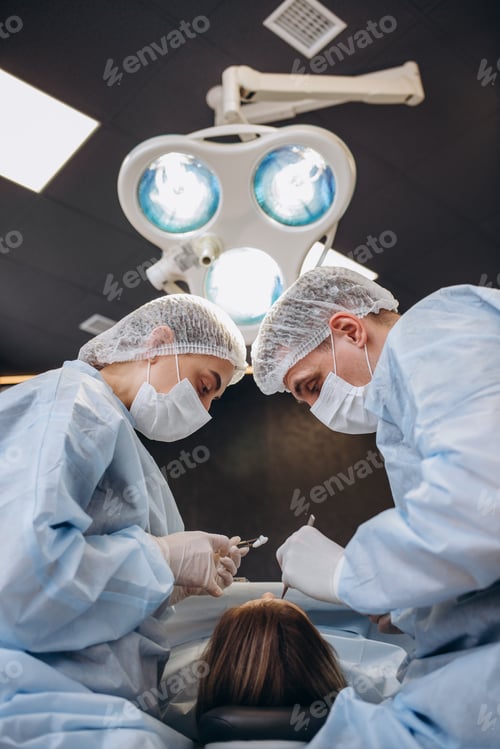 Preview: Professional medical team performing surgical operation in modern operating room.