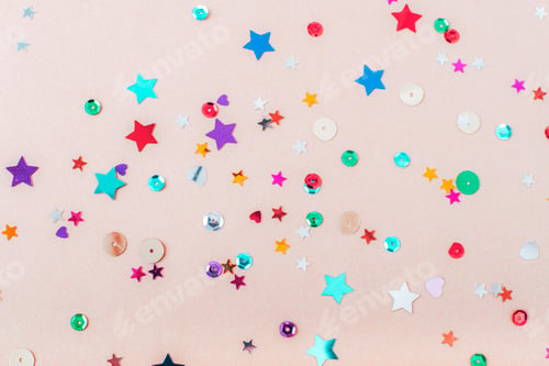 Preview: Colorful confetti on beige background. Christmas, New Year, Birthday party concept. Top view