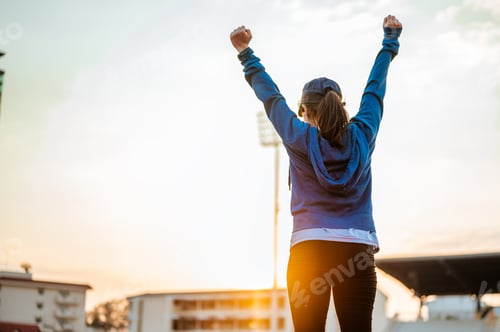 Preview: Healthy young woman hand fighting on track race at sport stadium in the city in the morning.Jogging,