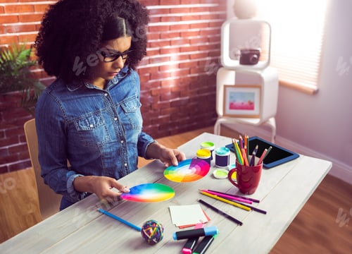 Preview: Casual businesswoman holding two color wheel in her office
