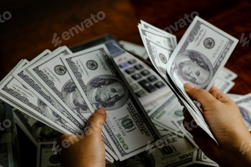 Preview: Businessmen women counting money on a stack of 100 US dollars banknotes