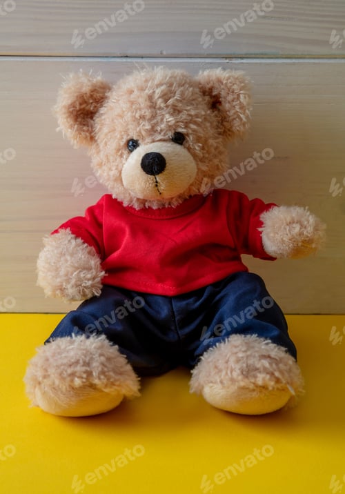 Preview: Teddy bear with red tshirt sitting on the floor, child room