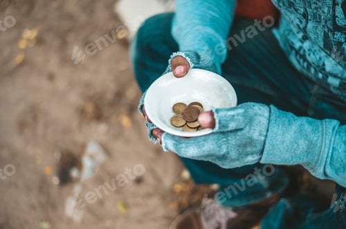 Preview: Man sitting beggar with a cup and money.