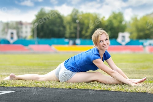 Preview: Young Fit Sporty Woman Stretching And Heating Up Before Training At A Stadium .Fitness Sport Model