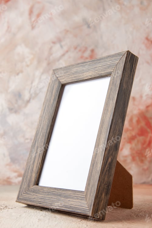 Preview: Front close view of brown empty wooden photo frame on pastel colors background