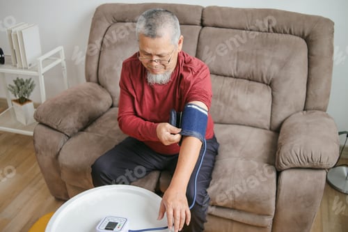 Preview: Asian Old Man Checking Blood Pressure And Heart Rate With Digital Pressure Gauge By Herself At Home