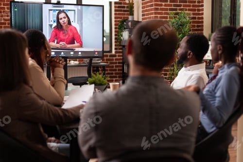 Preview: Businesspeople discussing company partnership with remote leader