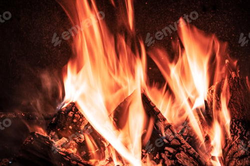 Preview: Fire orange tongues on black background in a brick fireplace