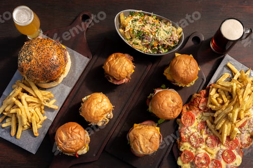 Preview: Top view of delicious fast food with burgers, French fries, and bee on the wooden table
