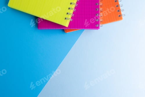 Preview: Three notebooks with binding and copy space on blue background
