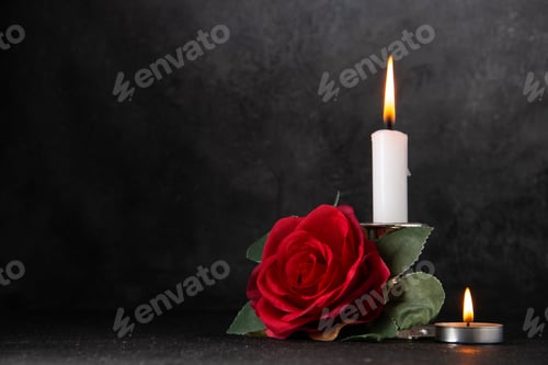 Preview: front view of burning candle with red flower on the gray background tank death war