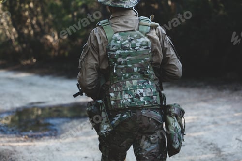 Preview: Camouflage Soldier in Forest Standing at the Ready