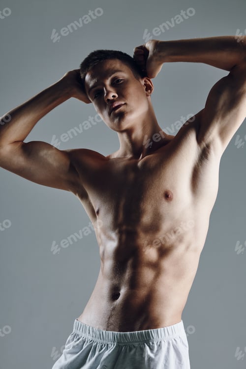 Preview: man with a pumped up torso holds his hands behind his head fitness workout model