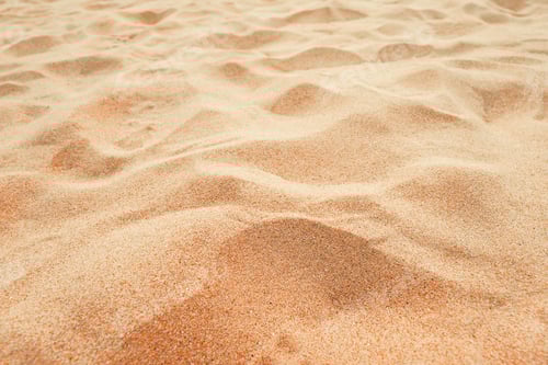 Preview: Beach sand background, close up, Low angle view of brown sandy surface in tropical resort.