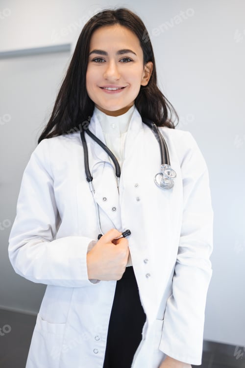 Preview: Smiling Woman Doctor with Stethoscope Wearing White Coat