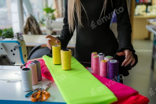 Preview: A seamstress happily creates with vibrant fabrics and thread