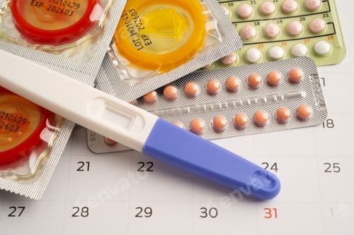 Preview: Pregnancy test and birth control pills on calendar, contraception health and medicine.