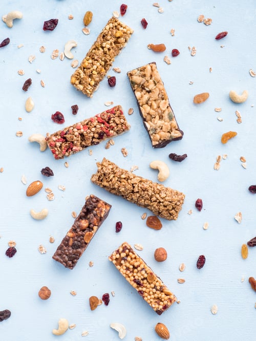 Preview: Set of different granola bars on blue background