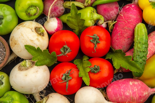 Preview: top view fresh vegetables cucumbers radish tomatoes onions with seasonings on the dark background
