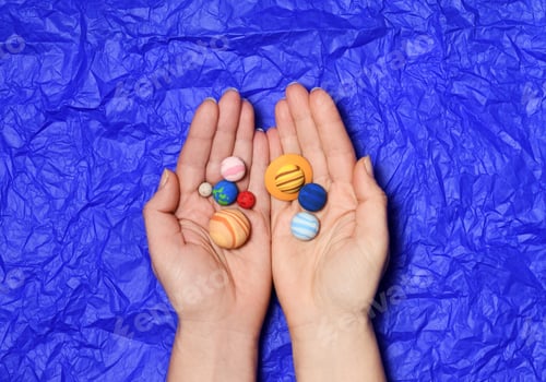 Preview: Hands with small solar system planets
