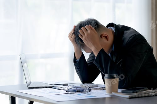 Preview: Asian businessman is stressed and eye strain and tired due to long working day on laptop computer